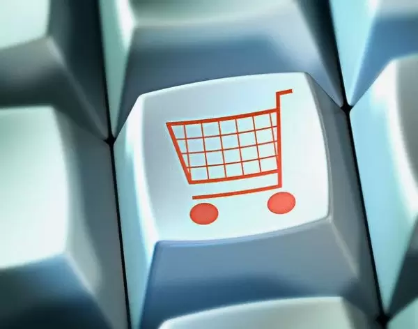 Shopping trolley on button of computer keyboard