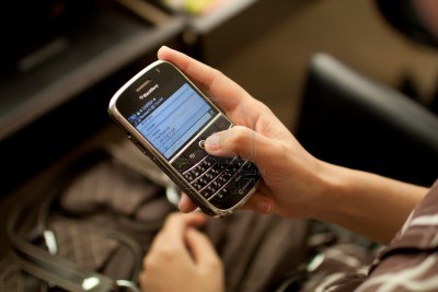 14564862 woman using blackberry messenger to chat with her friend